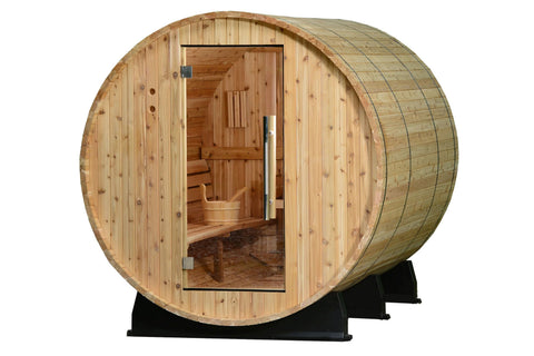 Cylindrical wood barrel sauna with light natural wood exterior, glass door showing interior benches and bucket, mounted on bl