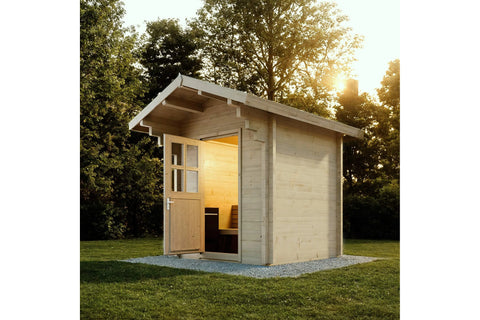 Wooden outdoor sauna with pitched roof, black trim, glass door with interior benches illuminated by warm lighting, on white b