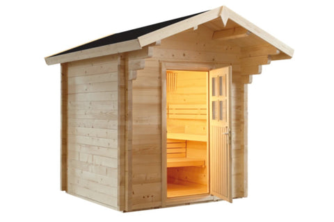 Wooden outdoor sauna with pitched roof, black trim, glass door with interior benches illuminated by warm lighting, on white b
