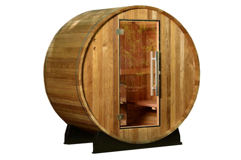 Cylindrical wooden barrel sauna with glass door, cedar construction, and metal bands, on black support stand against white ba