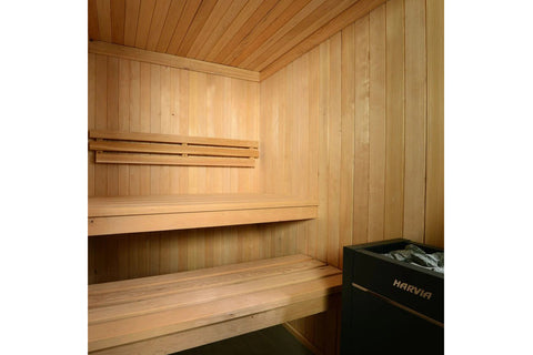Almost Heaven Serena 3-person indoor sauna with light wood construction, glass door, wooden benches, and black heater unit on