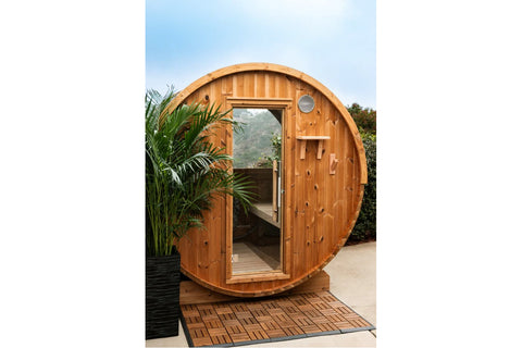 Half moon barrel sauna with cedar wood construction, glass door, and dark shingle roof on white background