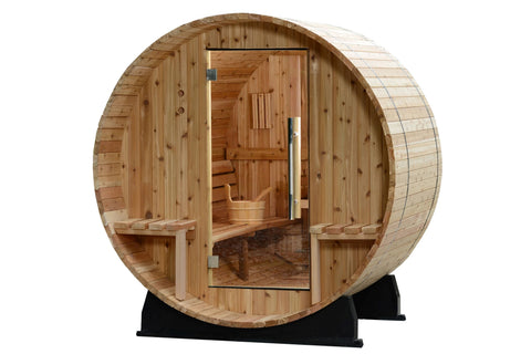 Round barrel sauna with light wood construction, glass door, wooden benches, and bucket visible inside, on black support base