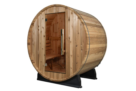 Almost Heaven Watoga barrel sauna with curved wooden exterior and glass door in backyard setting with potted plants