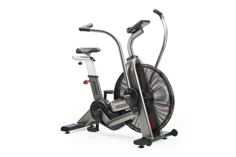Assault Elite air bike with large black fan wheel, gray and black frame, upright seat, dual handlebars, and digital display o