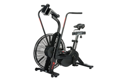 Black air bike with large fan wheel, upright handlebars, and stationary seat on white background