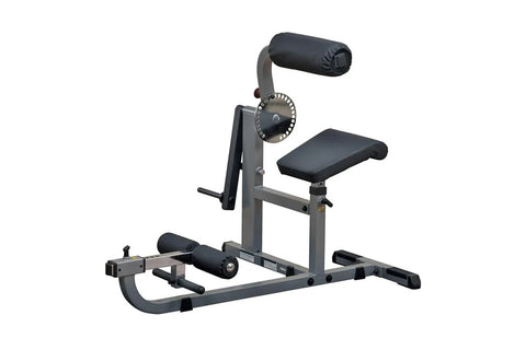 Body-Solid gray and black ab and back machine with padded seat, back support, leg extension, and adjustable resistance wheel 