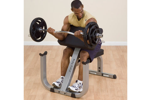 Body-Solid preacher curl bench with gray padded arm rest and seat, black steel frame, adjustable backrest on white background