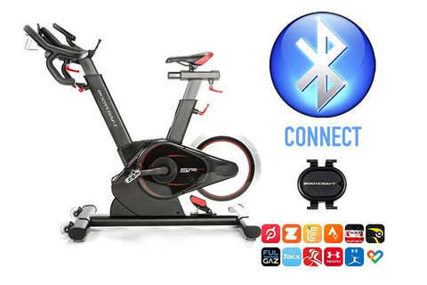Black and gray stationary exercise bike with curved handlebars, adjustable seat, and resistance wheel on white background