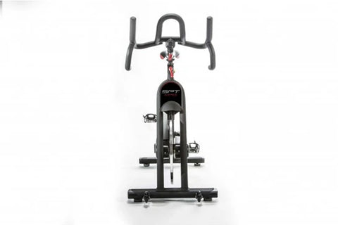 Black indoor training cycle with red accents, dual handles, red seat, and fixed wheelbase on white background
