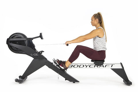 BodyCraft VR500 Pro rowing machine with white and black frame, black foot pedals, and digital display console on white backgr