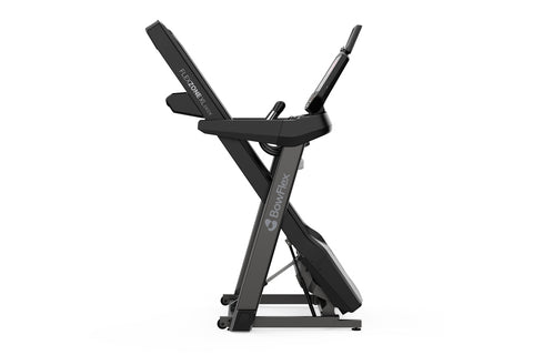 Black motorized treadmill with digital console displaying purple screen and tablet holder, featuring red accents on belt, on 