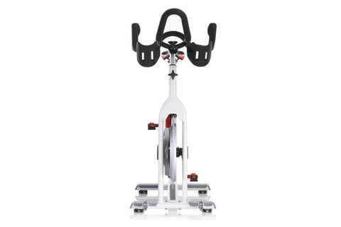 White and gray stationary exercise bike with red accents, black handlebars, and gray pedals on white background