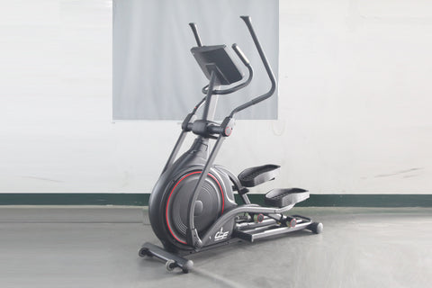 Black and gray stationary elliptical trainer with red accent trim and dual handle bars, displayed on concrete floor