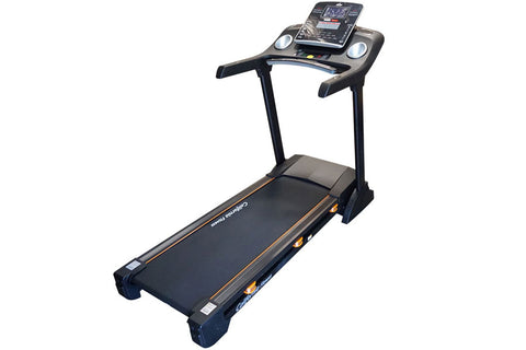 Black and orange folding treadmill with digital display console, dual handles, and cushioned running deck on white background
