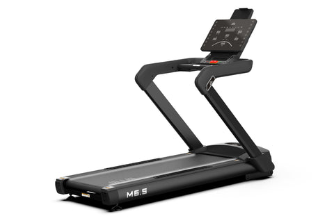 Black heavy-duty treadmill with digital console display, curved handrails, and M6.5 label on running deck, on white backgroun