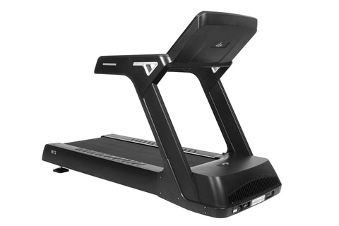 Black M12 treadmill with digital display console, orange accent trim, and cushioned running deck on white background