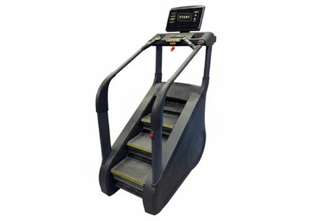 Black and gray commercial stair climber with digital display screen, handrails, and yellow-trimmed steps on white background
