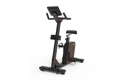 Black and brown upright exercise bike with digital display console, padded seat, and foot pedals on white background