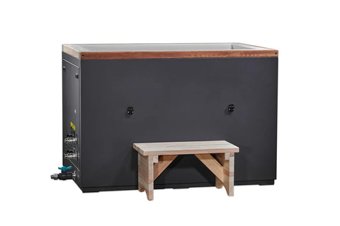 Black and white cold plunge tub with wood trim and light wood bench seat on white background