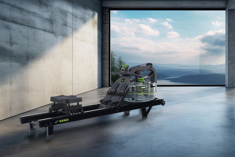 Black Dynamic Fluid S660 rowing machine with digital monitor, green accents, and water resistance chamber on white background