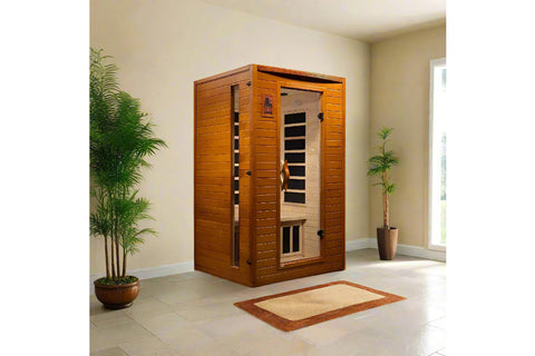 Golden cedar wood infrared sauna with glass door, digital control panel, and black heating elements visible inside on white b