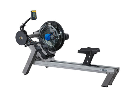 FluidRower E550 rowing machine with gray frame, black seat, blue resistance wheel, and digital monitor display on white backg