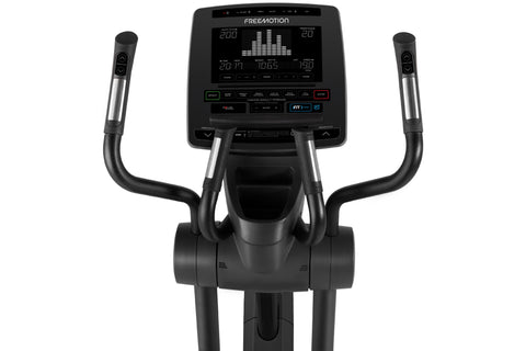 Black Freemotion elliptical machine with digital console, curved handles, and foot pedals on white background