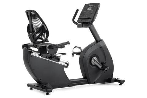 Black recumbent exercise bike with mesh backrest, digital console display, and pedal straps on white background