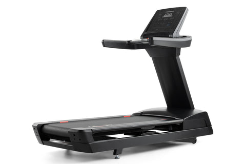 Black Freemotion t10.9b REFLEX treadmill with digital display console, handrails, and cushioned running deck on white backgro