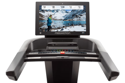 Black Freemotion t22.9 REFLEX treadmill with integrated tablet display mounted on upright console, shown on white background