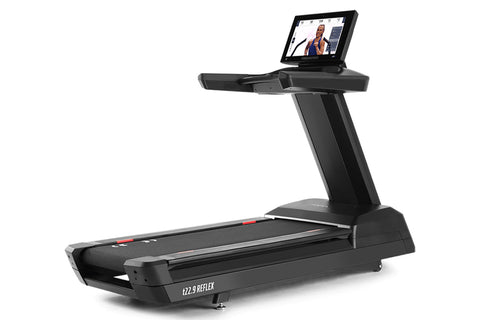 Black Freemotion t22.9 REFLEX treadmill with integrated tablet display mounted on upright console, shown on white background