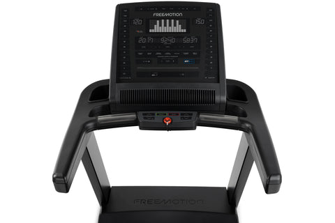 Black Freemotion t8.9b treadmill with digital display console, cushioned running deck, and folding frame on white background