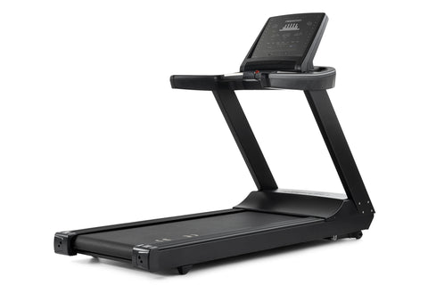 Black Freemotion t8.9b treadmill with digital display console, cushioned running deck, and folding frame on white background