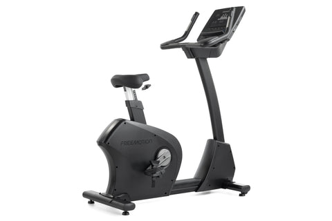 Black upright exercise bike with digital display console, padded seat, and stationary handlebars on white background