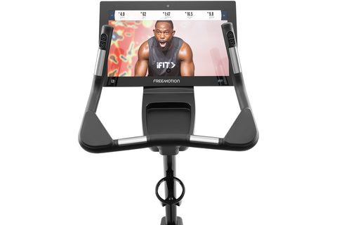 Freemotion u22.9 black upright exercise bike with digital display console and padded seat, on white background