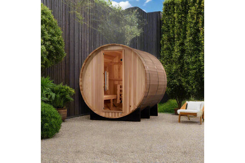 Golden Designs Arosa barrel sauna with natural cedar wood construction, open door showing interior wooden benches, on black s