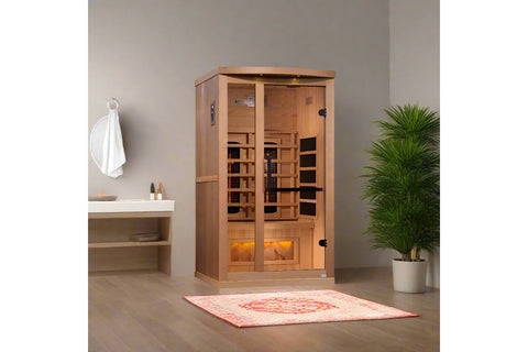 Cedar infrared sauna cabinet with dual glass doors, interior heating panels, and illuminated Himalayan salt bar at base on wh