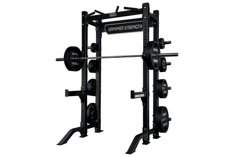 Black Hammer Strength HD Athletic NX half rack with weight plates mounted on both sides, open frame design on white backgroun