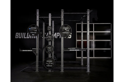 Hammer Strength HD Athletic NX Power Half Combo Rack with black weight plates and steel frame on black background