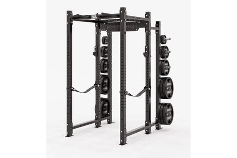 Black Hammer Strength power rack with weight plate storage pegs on right side, holding loaded barrels, on white background