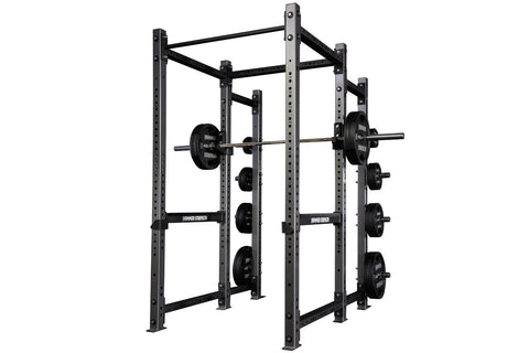 Black Hammer Strength power rack with weight plate storage pegs on right side, holding loaded barrels, on white background