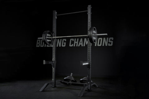 Black Hammer Strength squat stand with vertical posts, horizontal bar, weight plates labeled 45 lbs, and adjustable safety ar