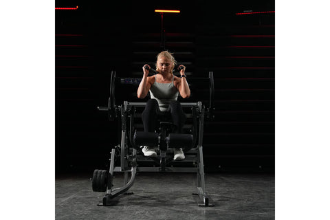 Black plate-loaded abdominal oblique crunch machine with padded seat and backrest on white background