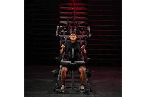 Black plate-loaded lat pulldown machine with dual handles, weight plate on left side, and foot platform, on white background