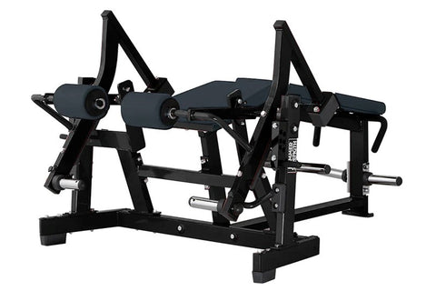 Black plate-loaded leg curl machine with dual padded footrests, adjustable seat, and metal frame on white background