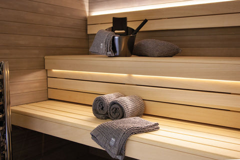 Harvia by Luhta charcoal gray sauna cushion made from cotton and linen, displayed with product packaging on white background