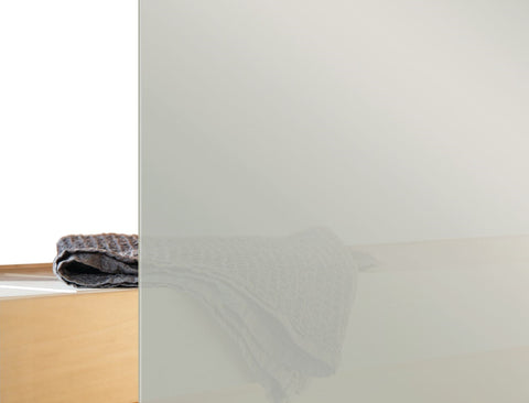 Black wood-burning stove with glass front door showing active flames, set in white frame against white shiplap wall, with bla