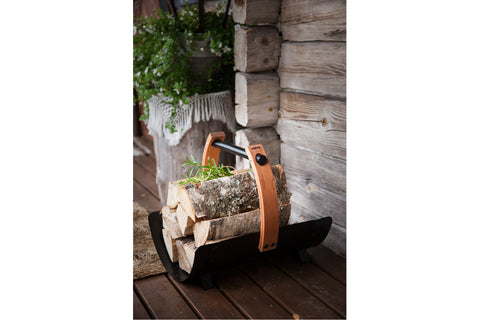 Harvia Legend sauna firewood basket with curved black metal body, wooden handles, and black metal rod on white background