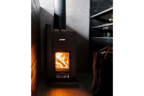 Black metal protective sheath for sauna stove with curved sides and rounded legs on white background
